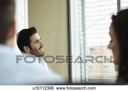 Smiling man in business meeting View Large Photo Image Stock Photograph - Smiling man in business meeting. Fotosearch