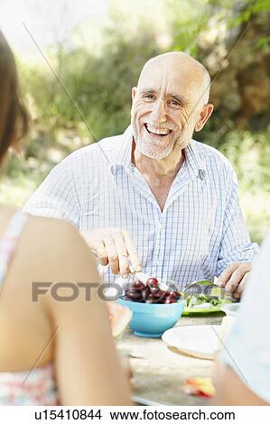 Smiling older man at picnic table View Large Photo Image Picture - Smiling older man at picnic table. Fotosearch
