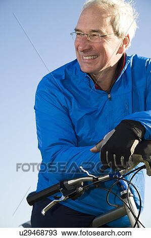 Smiling senior man with bicycle View Large Photo Image Stock Image - Smiling senior man with bicycle. Fotosearch