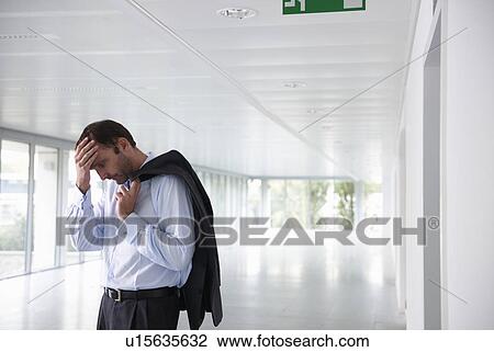 Stock Image - Stressed businessman in an empty office. Fotosearch