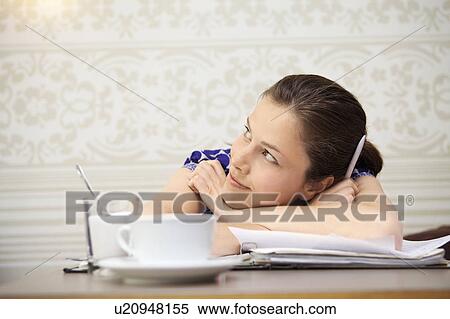 Stock Photography - Student studying in a cafe. Fotosearch