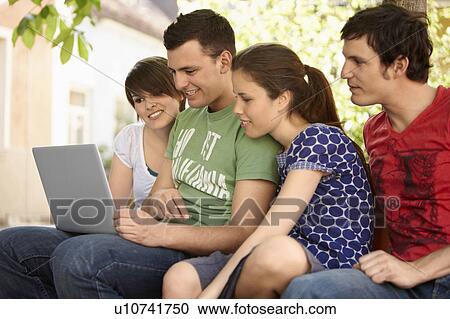 Stock Image - Students studying outdoors. Fotosearch