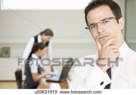 Thoughtful business man looks to camera View Large Photo Image Stock Photo - Thoughtful business man looks to camera. Fotosearch