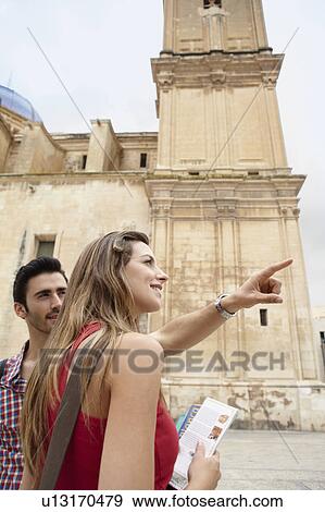 Stock Photo - Tourist couple in old city square. Fotosearch