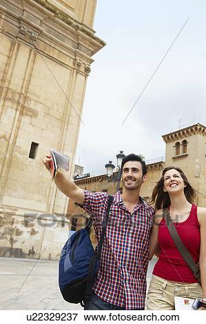 Stock Photo - Tourist couple in old city square. Fotosearch