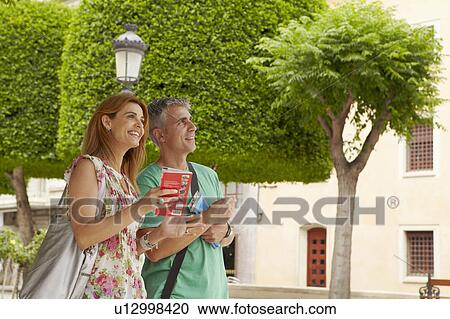 Tourists in city square View Large Photo Image Stock Image - Tourists in city square. Fotosearch