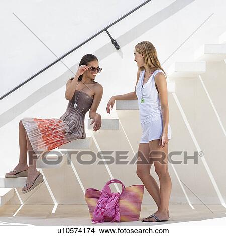 Trendy young woman talking on stairway View Large Photo Image Picture - Trendy young woman talking on stairway. Fotosearch