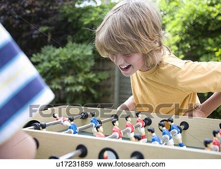 Two boys (8-11) playing table football View Large Photo Image Stock Photo - Two boys (8-11) playing table football. Fotosearch