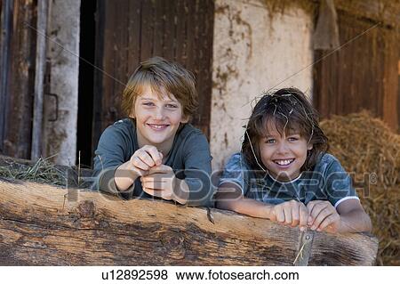 Two boys in haycart, happy View Large Photo Image Stock Photo - Two boys in haycart, happy. Fotosearch