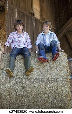 Two boys on haybale View Large Photo Image Stock Image - Two boys on haybale. Fotosearch