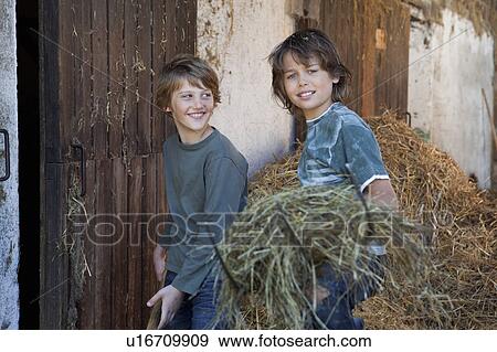 Two boys with hayforks, happy View Large Photo Image Stock Photo - Two boys with hayforks, happy. Fotosearch