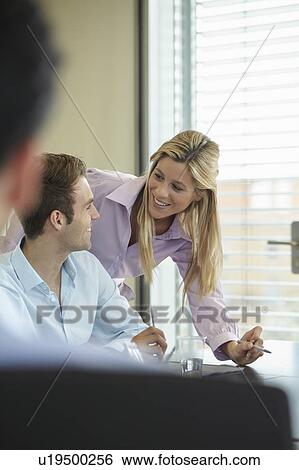 Two business colleagues discussing work View Large Photo Image Stock Photograph - Two business colleagues discussing work. Fotosearch