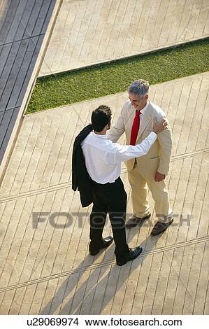 Two business men seen from above View Large Photo Image Picture - Two business men seen from above. Fotosearch
