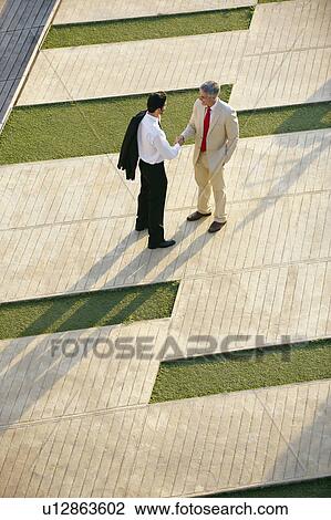 Two business men shaking hands View Large Photo Image Stock Image - Two business men shaking hands. Fotosearch