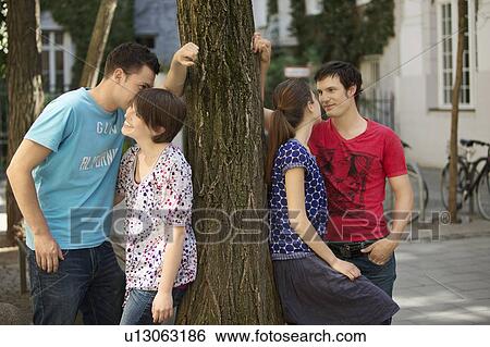 Two couple flirting View Large Photo Image Stock Photograph - Two couple flirting. Fotosearch