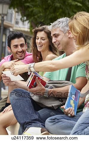 Two couples sharing holiday moment View Large Photo Image Stock Photo - Two couples sharing holiday moment. Fotosearch