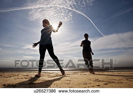 Two people running on beach View Large Photo Image Stock Photograph - Two people running on beach. Fotosearch