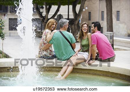 Two tourist couples by fountain View Large Photo Image Stock Image - Two tourist couples by fountain. Fotosearch