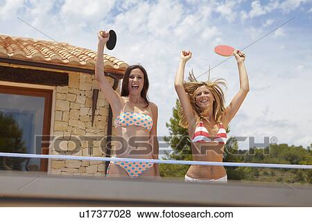 Stock Photo - Two winning women at ping-pong table. Fotosearch