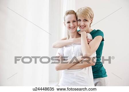 Two women hugging View Large Photo Image Stock Photography - Two women hugging. Fotosearch