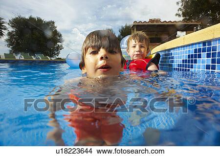 Two young boys in swimmingpool View Large Photo Image Picture - Two young boys in swimmingpool. Fotosearch