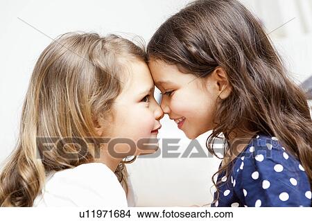 Picture - Two young girls stick together. Fotosearch