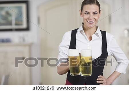 Stock Photo - Waitress carrying beer. Fotosearch