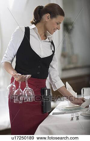 Waitress laying the table View Large Photo Image Stock Photo - Waitress laying the table. Fotosearch
