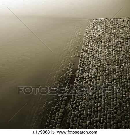 Water by cobbled path View Large Photo Image Stock Photography - Water by cobbled path. Fotosearch
