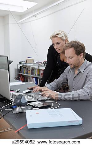 Web design team discussing a job View Large Photo Image Stock Image - Web design team discussing a job. Fotosearch