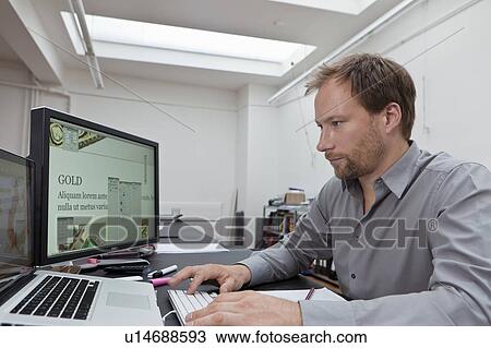 Stock Image - Web designer hard at work. Fotosearch