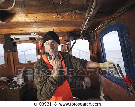 Wheelhouse fisherman speaks on radio View Large Photo Image Stock Photo - Wheelhouse fisherman speaks on radio. Fotosearch