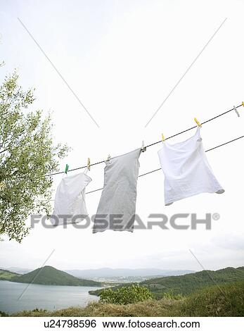 White washing hanging on line View Large Photo Image Stock Photograph - White washing hanging on line. Fotosearch