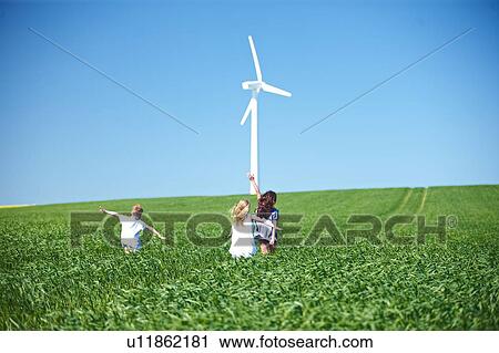 Wind turbine and childrens play in field View Large Photo Image Stock Image - Wind turbine and childrens play in field. Fotosearch