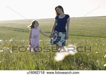 Stock Photo - Woman and child in sunny meadow. Fotosearch