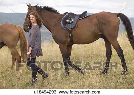 Stock Image - Woman and horses. Fotosearch