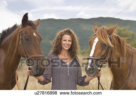 Stock Photo - Woman and horses. Fotosearch