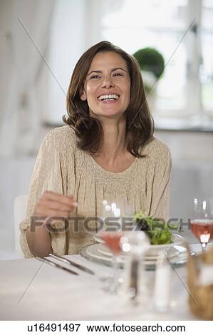 Stock Photo - Woman at a dinner party. Fotosearch