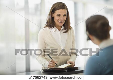 Stock Image - Woman at a reception. Fotosearch