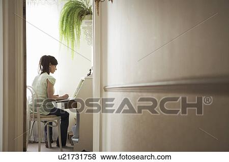 Stock Photo - Woman at desk in distance. Fotosearch