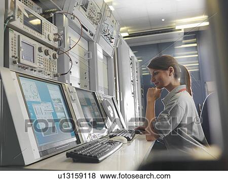 Woman at satellite dish control desk View Large Photo Image Stock Photo - Woman at satellite dish control desk. Fotosearch