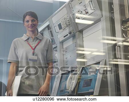 Woman at satellite dish control desk View Large Photo Image Stock Photograph - Woman at satellite dish control desk. Fotosearch