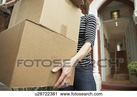 Woman carrying brown boxes from house View Large Photo Image Stock Image - Woman carrying brown boxes from house. Fotosearch