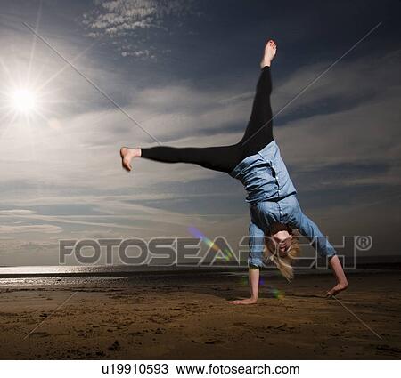 Woman cartwheeling on beach View Large Photo Image Stock Image - Woman cartwheeling on beach. Fotosearch