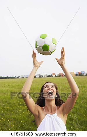 Stock Photo - Woman catching soccer ball. Fotosearch