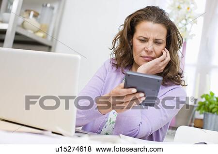 Woman doing account stuff View Large Photo Image Stock Photo - Woman doing account stuff. Fotosearch