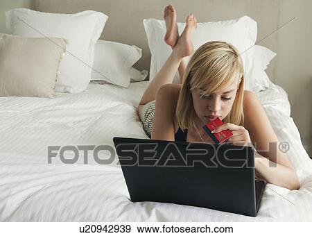 Stock Photo - Woman doing on line shopping. Fotosearch