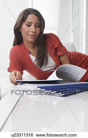 Woman doing paperwork at home View Large Photo Image Stock Photograph - Woman doing paperwork at home. Fotosearch