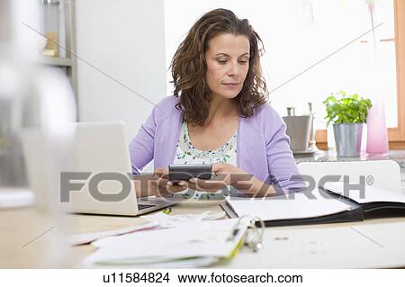 Woman doing paperwork View Large Photo Image Picture - Woman doing paperwork. Fotosearch