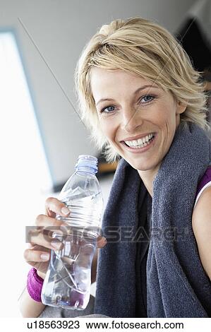 Woman drinking water after sports View Large Photo Image Stock Image - Woman drinking water after sports. Fotosearch
